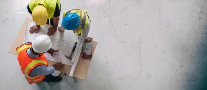Attorney reviewing details with construction workers